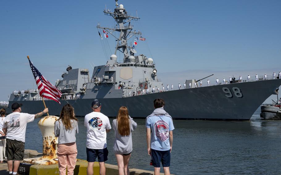 Relatives of sailors assigned to the destroyer USS Forrest Sherman watch as the ship departs from its homeport of Norfolk, Va., on June 11, 2022, for the European theater.