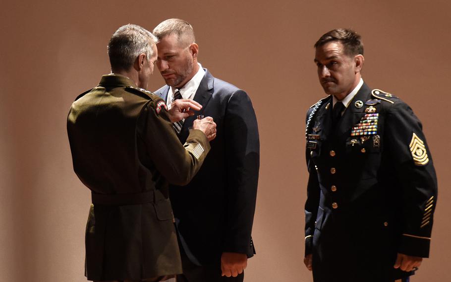 
John M. Collett is presented the Silver Star on Friday, Oct. 1, 2021 at Fort Benning, Ga., by Army Gen. Richard Clarke, head of U.S. Special Operations Command for actions in the infamous October 1993 Battle of Mogadishu. Collett, then a specialist, was a squad automatic weapon gunner with the Army’s 3rd Battalion, 75th Ranger Regiment during the battle made famous by the book and movie “Black Hawk Down.” 