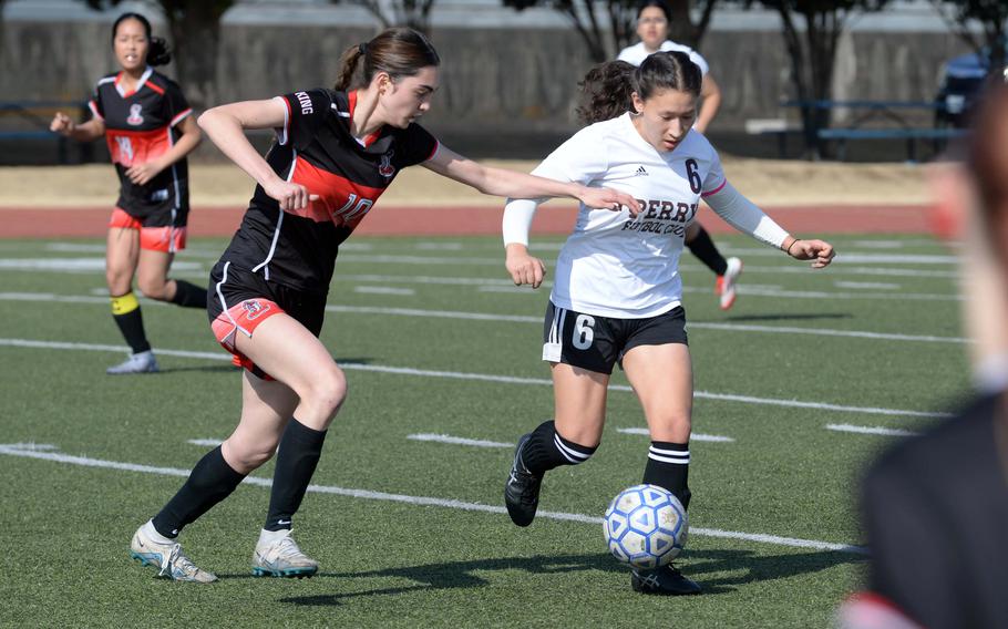 Joanna Hall and Sasha Malone chase the ball.