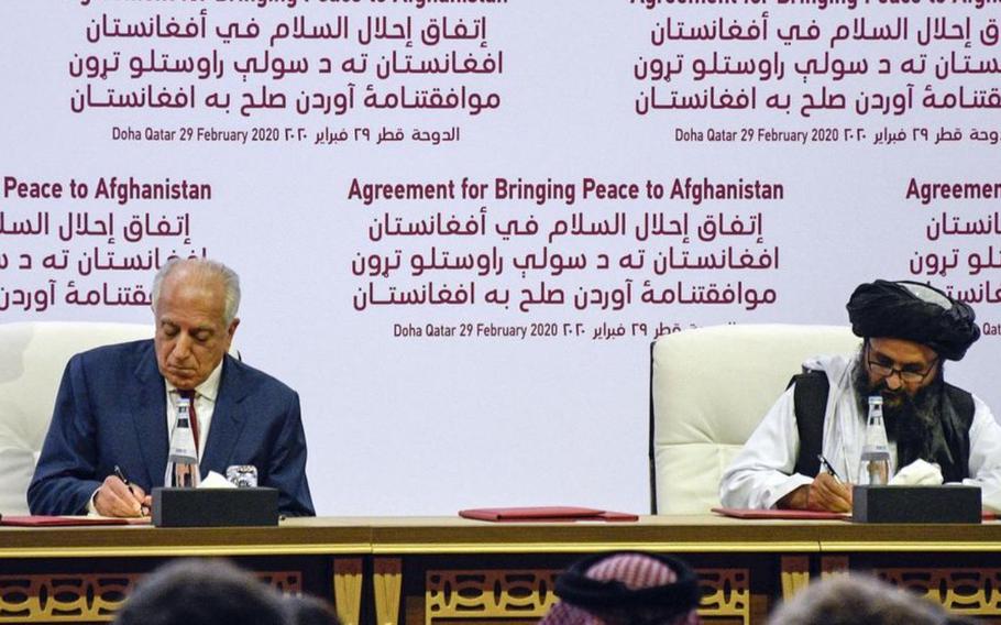 Zalmay Khalilzad, American special envoy for Afghan reconciliation, signs a peace deal with the Taliban, along with Mullah Abdul Ghani Baradar, the militant group’s top political leader, in Doha, Qatar, Feb. 29, 2020. 
