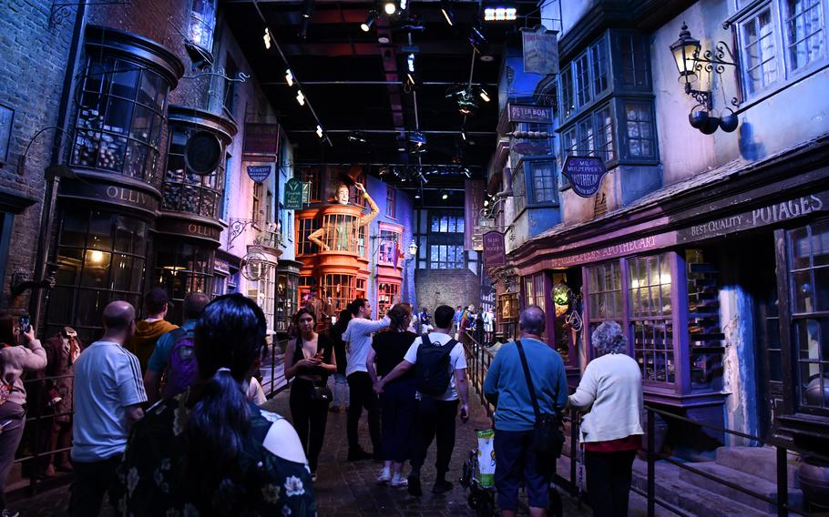 Visitors at the Warner Bros. studio tour for the Harry Potter movies walk through the set of Diagon Alley.