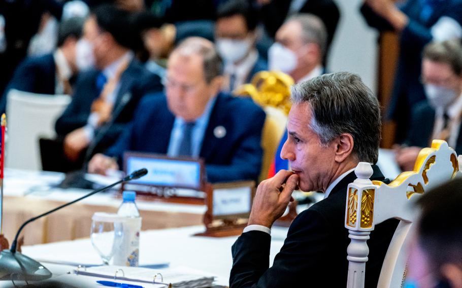 Secretary of State Antony Blinken, right, and Russian Foreign Minister Sergey Lavrov, left, are seated close together during an east Asia summit foreign ministers meeting at Sokha Hotel in Phnom Penh, Cambodia.