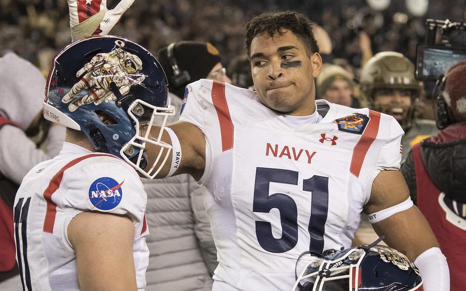 Navy’s Nicholas Straw (51) consoles a teammate moments after Army’s Black Knights beat the Midshipmen 20-17 in double overtime in the 123rd Army-Navy football game played at Philadelphia’s Lincoln Financial Field on Saturday, Dec. 10, 2022.