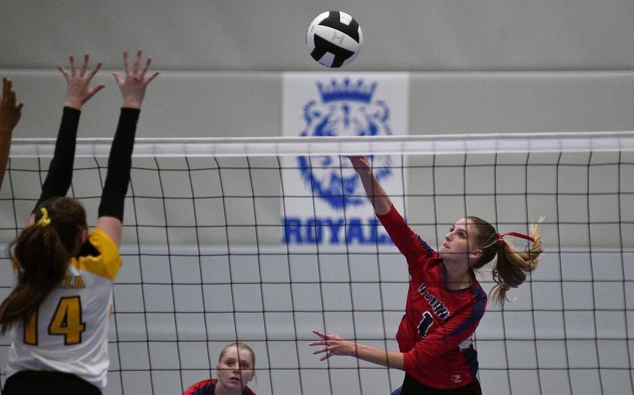 Aviano's Jaycee Spence spikes the ball at the net while Vicenza's Alexandra Nelson goes up for a block during a Division II semifinal at the DODEA European volleyball championships on Oct. 27, 2023, at Ramstein High School on Ramstein Air Base, Germany.