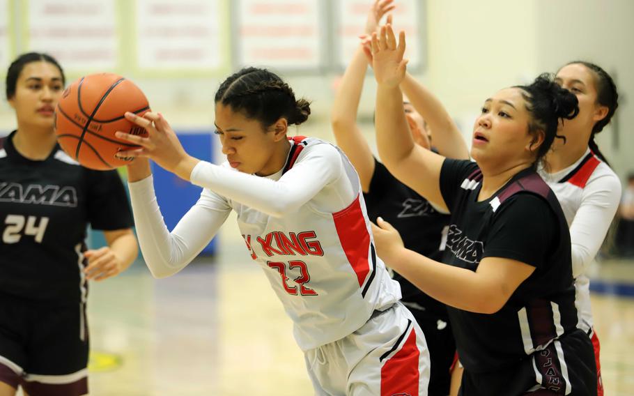 King's Mila Nishimura-Reed snags a rebound in front of Zama's Deborah McClendon.