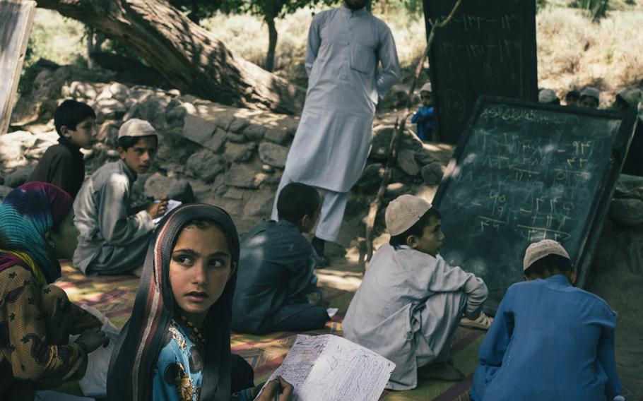 Children attend class in Marawara district, Afghanistan, on July 6, 2020. There is no school building, so classes are held outdoors. 