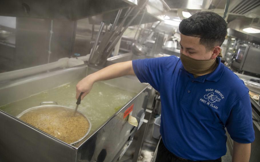 Seaman Recruit Dylan Ludwick, assigned to the aircraft carrier USS Gerald R. Ford, stirs pasta in the ship's forward mess decks in 2020. Ford is the first aircraft carrier equipped with conglomerate galleys. Their unique design and state-of-the-art equipment simplify food service on the ship.