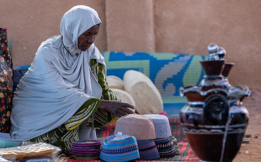A woman sets up handmade items for sale Dec. 2, 2023, at Base 201 in Agadez, Niger. The bazaar highlighted local Nigerien women and afforded cultural opportunities to the U.S. personnel stationed at the base.