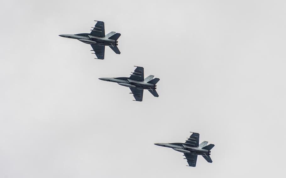 Three F/A-18 Super Hornets fly in formation over the  aircraft carrier USS Harry S. Truman in the Mediterranean Sea on Feb. 16, 2022.