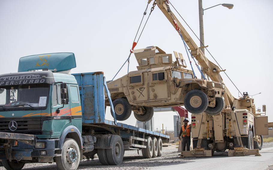 U.S. soldiers and contractors pack up Humvees in Kandahar, Afghanistan, July 13, 2020. While work contracts in the country are now being closed out, other loose ends from the collapse of the Afghan government include an estimated $7.12 billion worth of military equipment that remain in Afghanistan. 