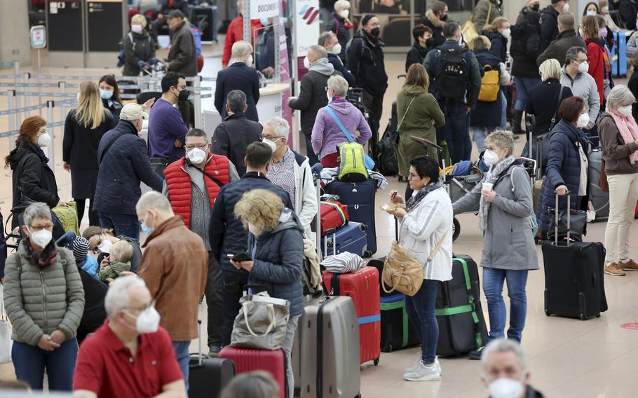 Numerous travelers wait in long lines at Hamburg Airport on Tuesday, March 15, 2022. Air travel was disrupted across Germany on Tuesday as security personnel at several airports in the country staged walkouts to demand higher wages.