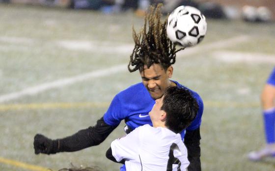 Yokota's Damian Abrams heads the ball against Zama American's Michael Gough during Friday's DODEA-Japan boys soccer season opener at Yokota's Fred Bonk Memorial Field. The Trojans won 1-0, their first win over the Panthers in four years.