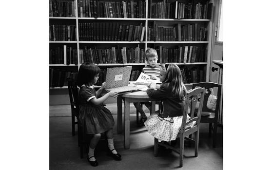 Paris, France, July 16, 1960: An American girl (left) and two French younsters in the reading room set aside for children at the American Library in Paris. The library was established after World War I when a large collection of books supplied to American Expeditionary Forces was gathered together. With a small endowment from the American Library Associations, the library opened in 1920 under the sponsorship of a committee of Americans living in Paris.

METATAGS: Europe; France; American culture; library; books; children; child; girl; boy; stacks; bookshelves; reading