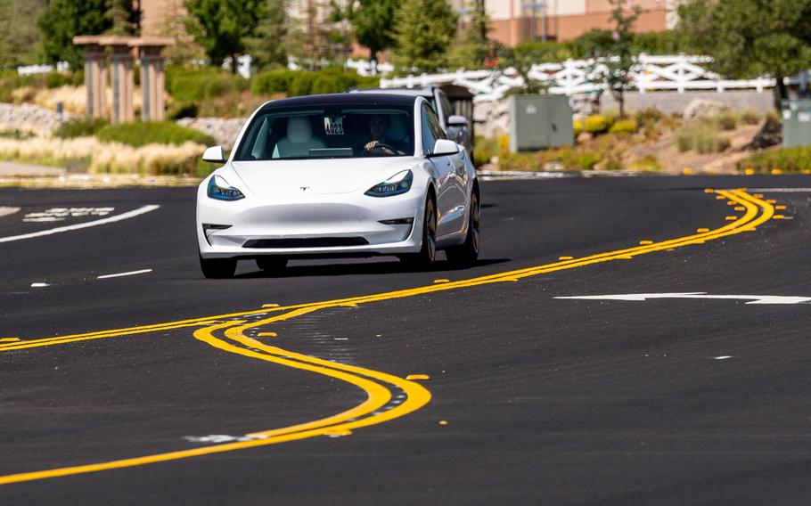 A Tesla Model 3 travels on a road in Rocklin, Calif., on July 21, 2021. According to reports on Friday, March 25, 2022, the world’s biggest manufacturer of electric-vehicle batteries is scouting sites for a new $5 billion battery plant in North America. 