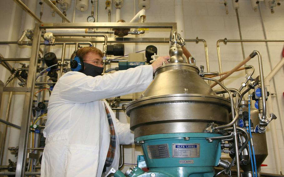Biologist Joe Kragl operates a centrifuge at Aberdeen Proving Ground, Md. The Defense Advanced Research Projects Agency recently launched a program that test mobile systems for converting oxygen, carbon dioxide, water and electricity into microbes that produce “food molecules.”