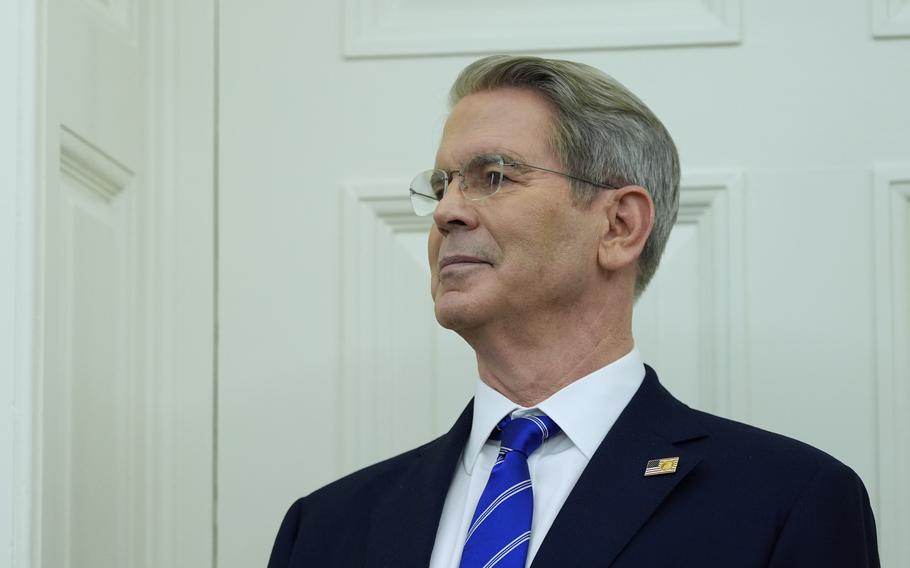 Treasury Secretary Scott Bessent stands in a suit.