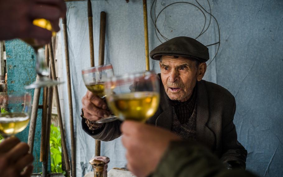 Nikolai Manailo, 99, a veteran of World War II, raises a glass in Nadtochii, outside Kharkiv, Ukraine, on Victory Day. He says he wishes it were possible for the two sides to sit down over a drink and sort out their differences.