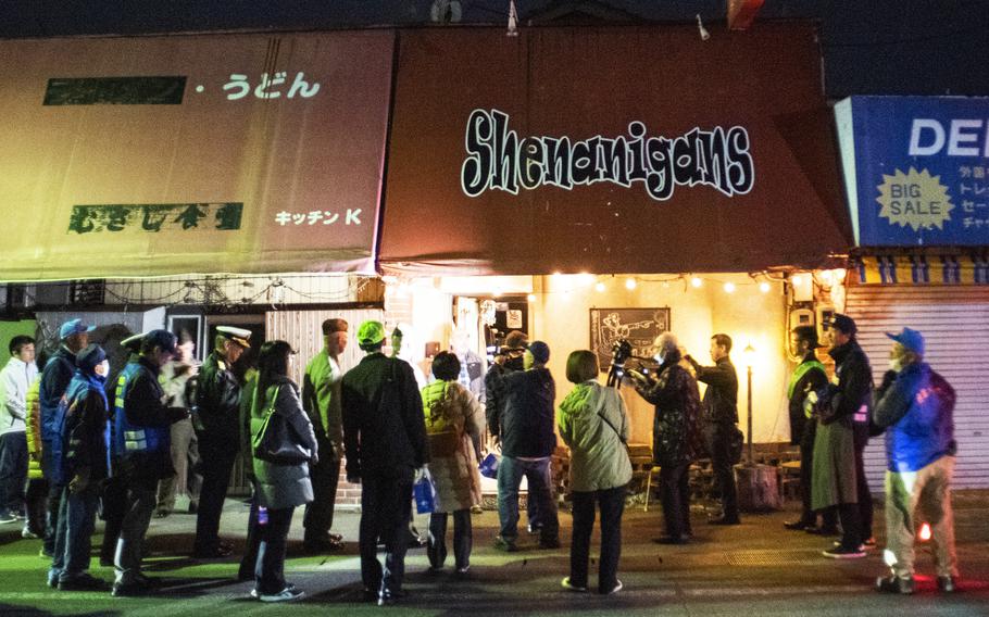 U.S. and Japanese officials visit local business during a joint patrol of Iwakuni city, Japan, Dec. 8, 2023. 