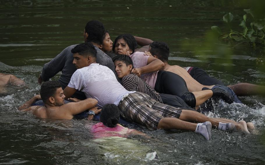 Migrants cross the Rio Bravo on an inflatable mattress into the United States from Matamoros, Mexico, on May 9, 2023. The image was part of a series by Associated Press photographers Ivan Valencia, Eduardo Verdugo, Felix Marquez, Marco Ugarte Fernando Llano, Eric Gay, Gregory Bull and Christian Chavez that won the 2024 Pulitzer Prize for feature photography.
