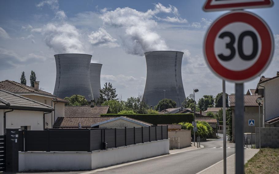 Cooling towers of the Bugey nuclear power station, operated by Electricitie de France SA, are seen beyond residential houses in Bugey, France, on July 19, 2023.