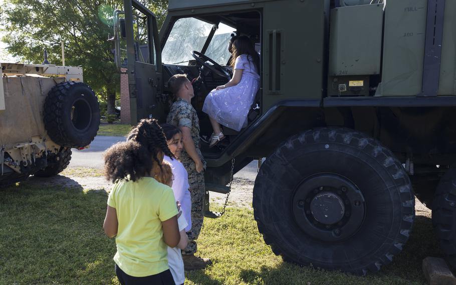 U.S. Marine Corps Cpl. Easton Bevins, a native of Kentucky and a motor vehicle operator with Marine Wing Support Squadron (MWSS) 271, explains the features of an MKR18 Logistics Vehicle System Replacement to students during a career fair at Oaks Road Academy in New Bern, N.C., Friday, April 19, 2024.