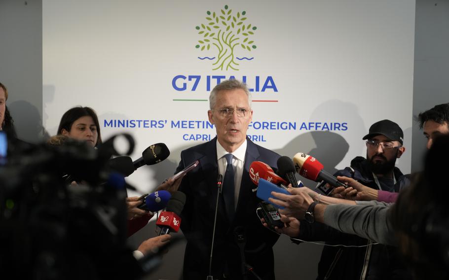 NATO’s Secretary General Jens Stoltenberg, center, speaks to reporters in the Italian resort island of Capri, Thursday, April 18, 2024, where he’s attending a G7 foreign Ministers meeting.