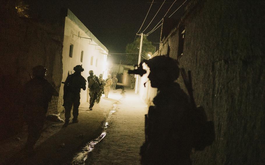 Elite Afghan forces conduct a clearing operation in an area under Taliban control in the northern edge of Kunduz, Afghanistan, on July 15.