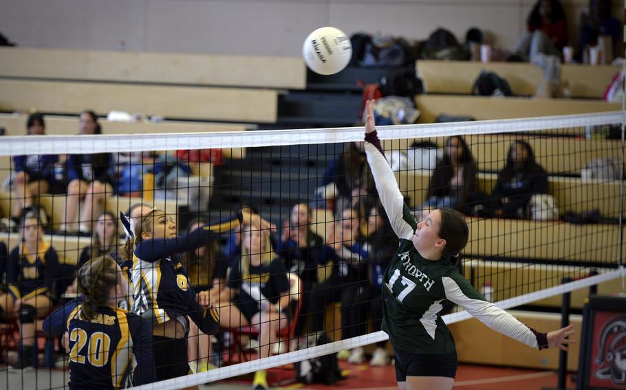 AFNORTH Lion Isabella Guest rises to attempt a block against a shot from Ansbach Cougar Laila McIntyre during the DODEA Division III European volleyball championship on Oct. 27, 2023, in Kaiserslautern, Germany.
