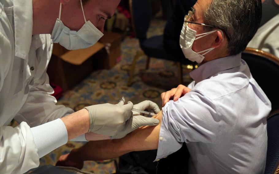 New Sanno Hotel security worker Munechika Sato gets a COVID-19 vaccine at the U.S. military-run facility in central Tokyo, Wednesday, Feb. 16, 2022.