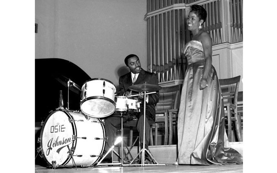 Jazz singer Sarah Vaughan, accompanied by famed jazz drummer Roy Haynes onstage in Kaiserslautern, Germany, Oct. 12, 1954. The stop was one of many on Vaughan’s European tour.