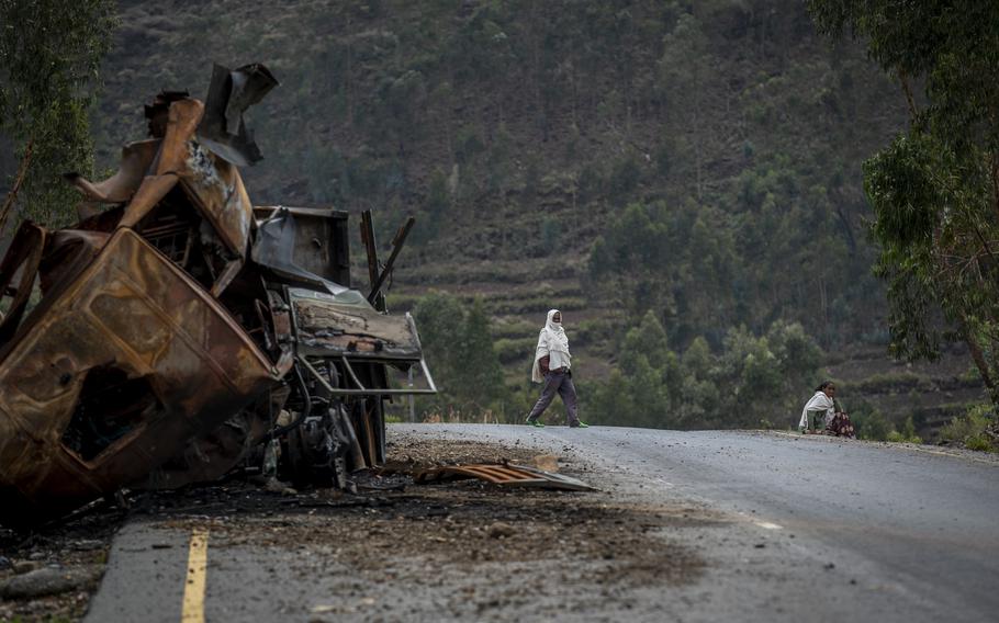 A man crosses near a destroyed truck on a road leading to the town of Abi Adi, in the Tigray region of northern Ethiopia on May 11, 2021. A spokesman for Tigrayan authorities said Tuesday, Sept 20, 2022 that Eritrea had launched a full-scale offensive along the country's border with northern Ethiopia.