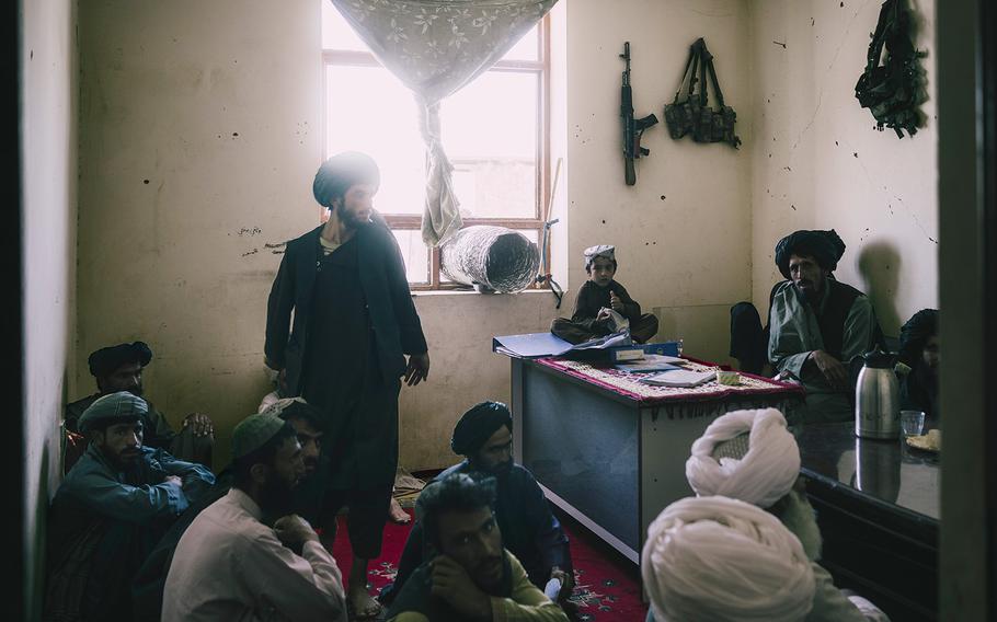 A group of elders register to have their cases heard by a Taliban court in the office of the district governor in Marja, on June 13, 2022.