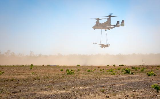 An MV-22B Osprey with Marine Medium Tiltrotor Squadron 363, Marine Rotational Force  Darwin, prepares to deliver a howitzer after an airfield seizure exercise at Mount Bundey Training Area, Australia, July 21, 2021. The exercise used concepts from Force Design 2030, the 10-year plan to reshape the Marine Corps. 
