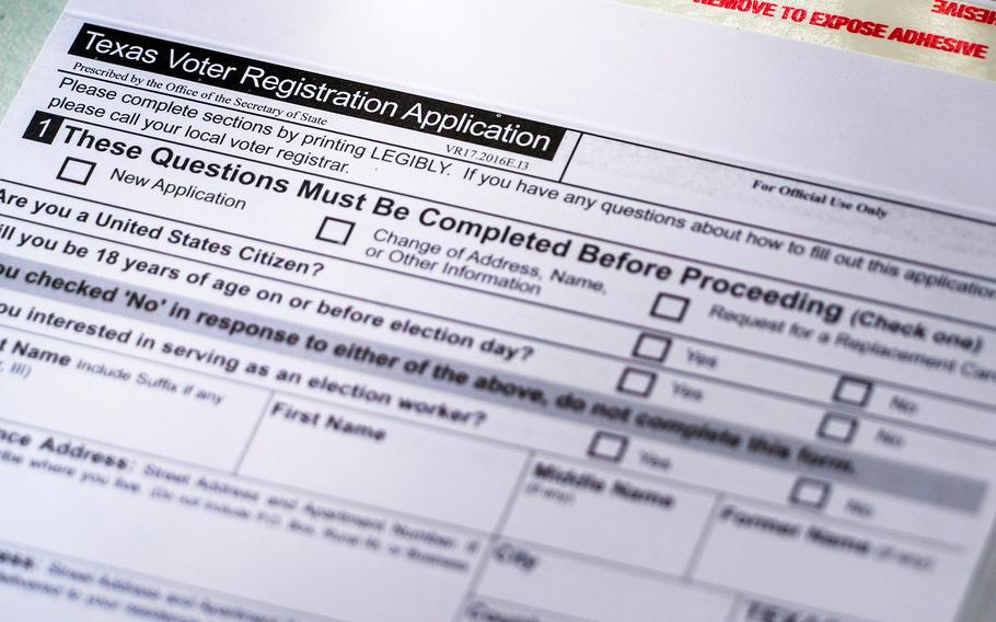 Voter registration materials seen at a volunteer registration table during the Arlington Independence Day Parade on Monday, July 5, 2021, in Arlington, Texas. The White House on Tuesday announced a host of plans to boost voter registration and participation rates.