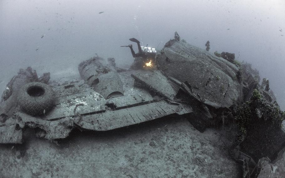 A diver inspects the wing of a World War II-era B-24 bomber lying in waters off Croatia during a two-week search mission in August 2022.