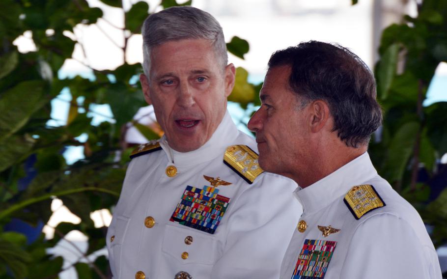 Adm. Stephen Koehler, commander of U.S. Pacific Fleet, left, speaks with U.S. Indo-Pacific Command chief Adm. John Aquilino after a change-of-command ceremony at Joint Base Pearl Harbor-Hickam, Hawaii, on April 4, 2024.