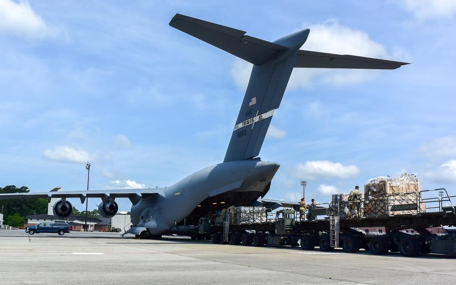 Airmen load cargo onto an aircraft