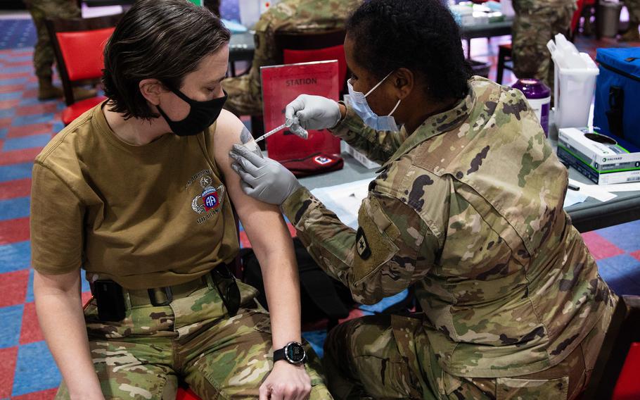 120p na            Command Sgt. Maj. Eva Commons, the Headquarters and Headquarters Battalion, 82nd Airborne Division command sergeant major, receives the COVID-19 vaccination at Sports USA on Fort Bragg, N.C., January 14, 2021.