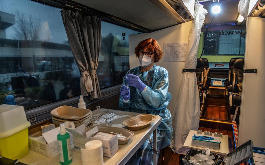 Dorothea Esser, a pharmacist, prepares doses of the Pfizer/BioNTech COVID-19 booster vaccine in a vaccination bus in Kaiserslautern, Germany, Nov. 30, 2021. Vaccine buses have been a major part of public health efforts in the state of Rheinland-Pfalz, home to tens of thousands of U.S. military members.