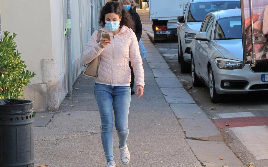 A woman wears a mask while walking in Vicenza, Italy, in 2020. Beginning May 1, 2022, Italy plans to drop most of its coronavirus restrictions.