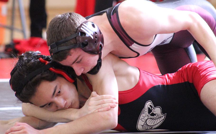 Matthew C. Perry's Jacob Morton gains the edge on E.J. King's Andre Pyryt at 122 pounds during Saturday's DODEA-Japan wrestling tri-meet. Morton won by pin in 5 minutes, 11 seconds and the Samurai won the dual 44-21.