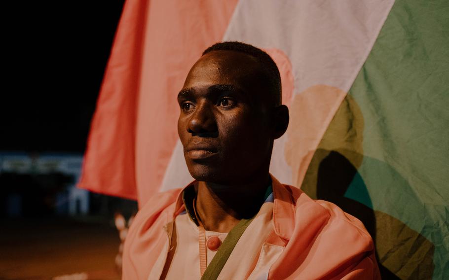 Adamo Soumana, 21, dressed in the colors of Niger, at a concert at the Rond-Point de l’Escadrille.