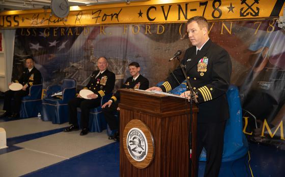 Capt. Mac Harkin, Commodore of Destroyer Squadron 2 (DESRON 2) speaks during a change of command ceremony aboard the first-in-class aircraft carrier USS Gerald R. Fords (CVN 78), Feb. 17, 2023.  Harkin, fleeting up from his position as Deputy Commodore, DESRON 2, relived Capt. Stefan Walch who led DESRON 2 since December 2021. (U.S. Navy photo by Mass Communication Specialist 3rd Class Aaron Arroyo)