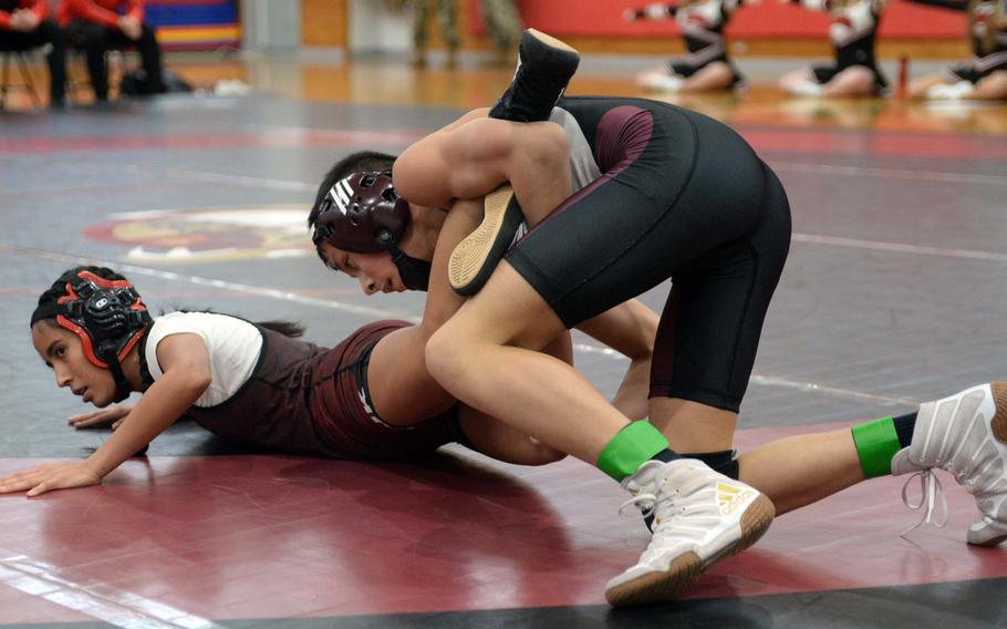 Matthew C. Perry's Sebastian Campbell gets a leg lace on E.J. King's Fernanda Diaz during Saturday's DODEA-Japan wrestling dual meet. Campbell won by technical fall 12-0 in 53 seconds and the Samurai won the meet 27-25.