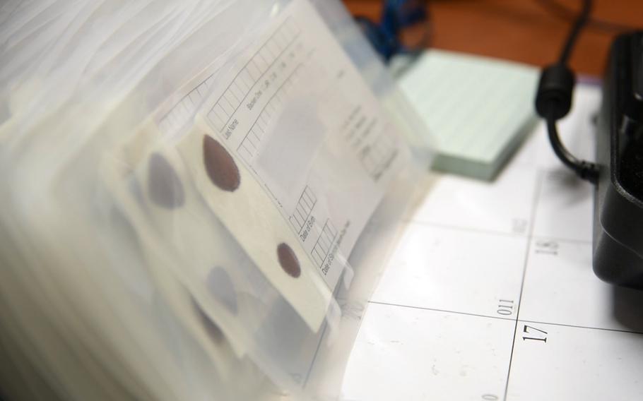 Blood-sample cards sit on a desk at the Armed Forces Repository of Specimen Samples for the Identification of Remains at Dover Air Force Base, Del., Jan. 30, 2019.