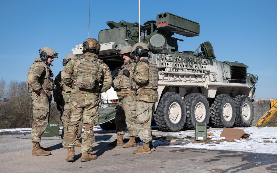 Soldiers with 5th Battalion, 4th Air Defense Artillery Regimen  stand next to a maneuver short-range air defense, or M-SHORAD, system, at Grafenwoehr Training Area, Germany, Feb. 9, 2023.