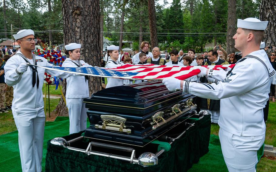 Navy Reserve Center Sacramento funeral honor detail sailors ceremoniously fold the flag above retired Lt. Cmdr. Lou Conter’s casket at his memorial service.