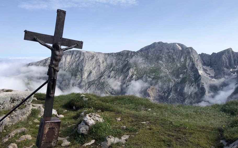 A crucifix appears at Schneibstein at Berchtesgaden National Park in Germany on on June 28, 2022, marking the border with Austria. Many of the peaks in the park have crosses or crucifixes at their highest points, erected by local mountaineers.
