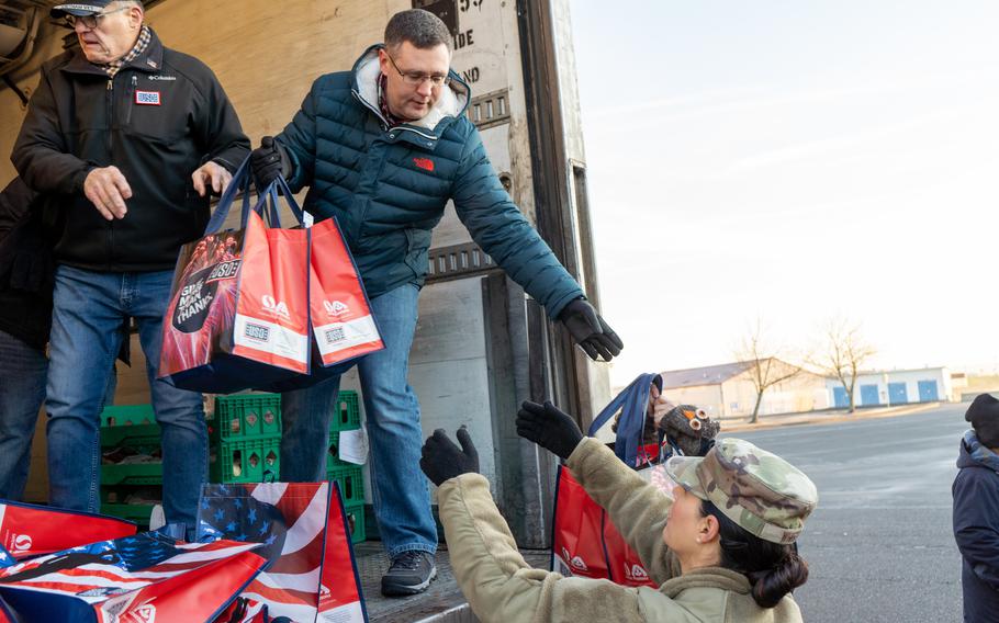 Volunteers unload donations during a food drive Dec. 17, 2022, in Portland, Ore. The event delivered canned goods and seasonal staples to service members in need.