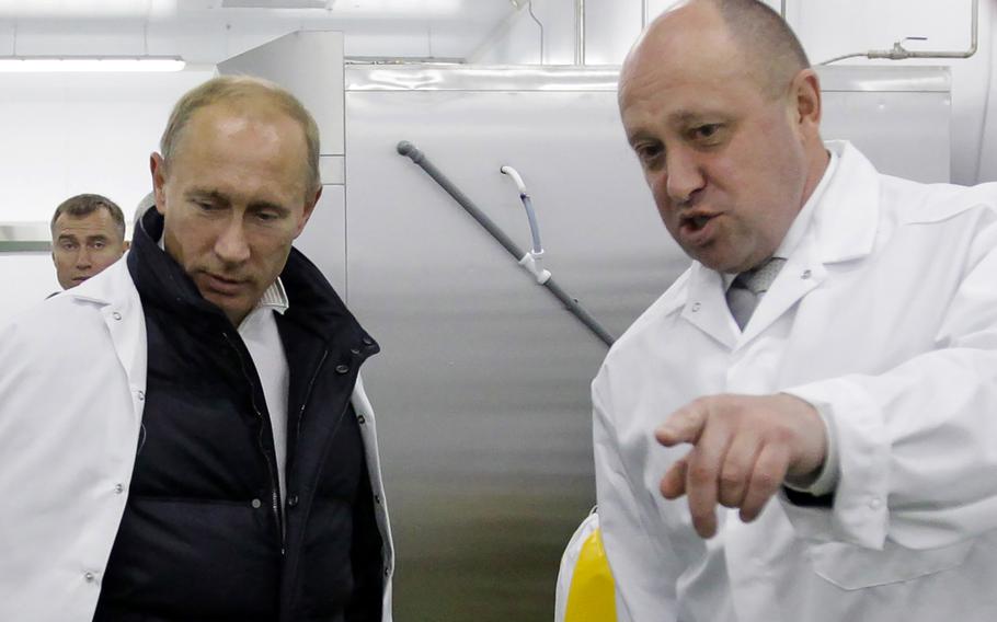 Businessman Yevgeny Prigozhin shows Russian Prime Minister Vladimir Putin his school lunch factory outside St. Petersburg on Sept. 20, 2010.